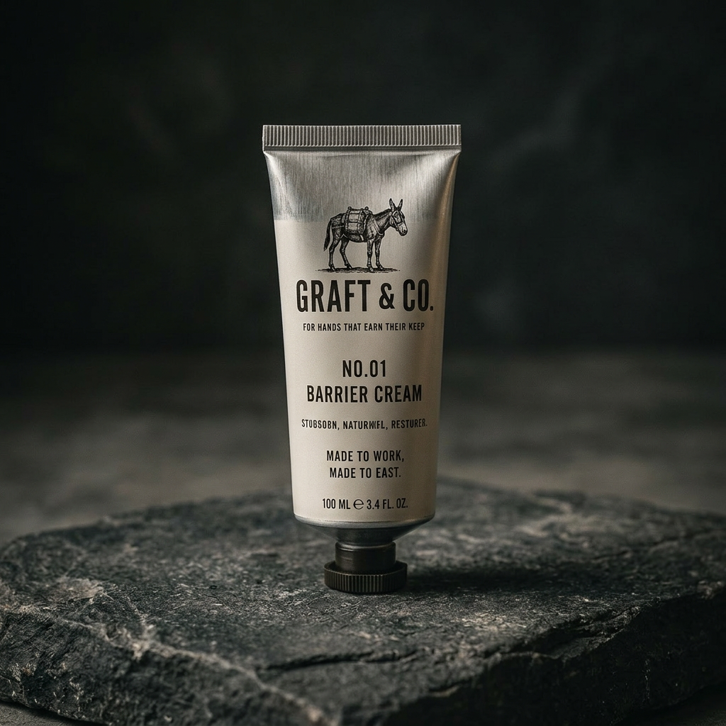 Graft & Co. No.01 Barrier Cream tube resting on dark stone